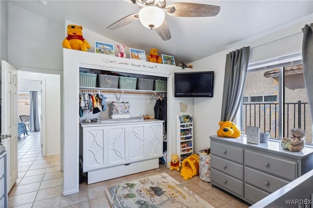 bedroom featuring a closet, multiple windows, ceiling fan, and light tile patterned floors