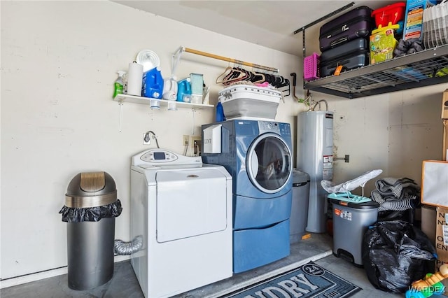 washroom featuring water heater, laundry area, and separate washer and dryer