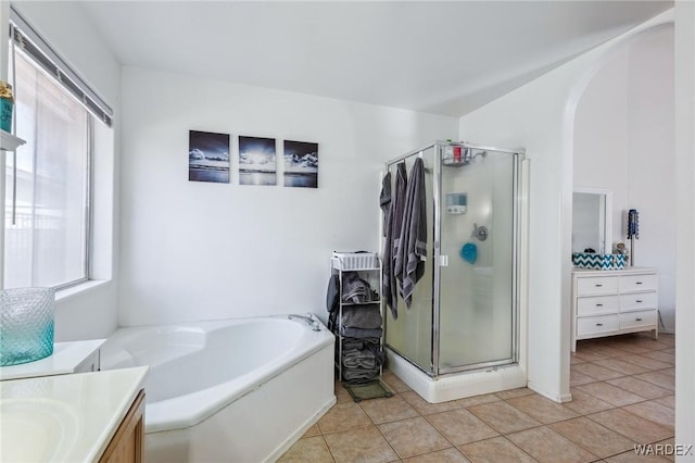 full bath with tile patterned flooring, a shower stall, and vanity