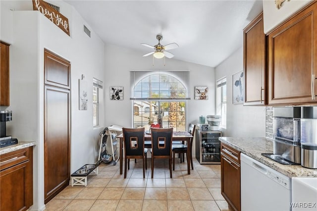 dining room featuring a ceiling fan, visible vents, vaulted ceiling, and light tile patterned floors