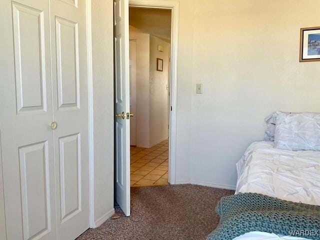 carpeted bedroom with tile patterned floors