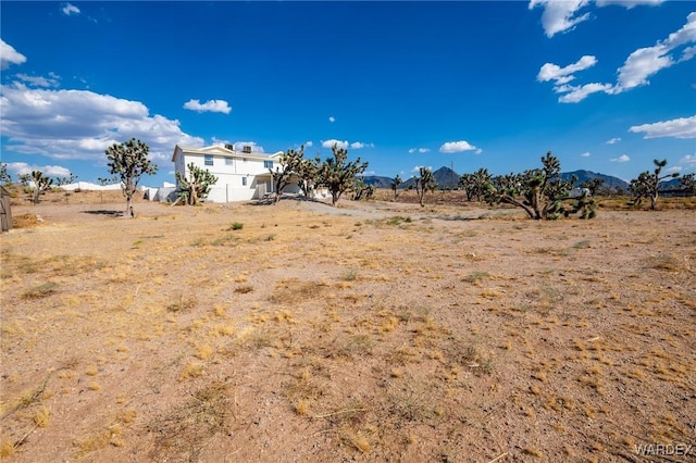 view of yard featuring a mountain view and a rural view
