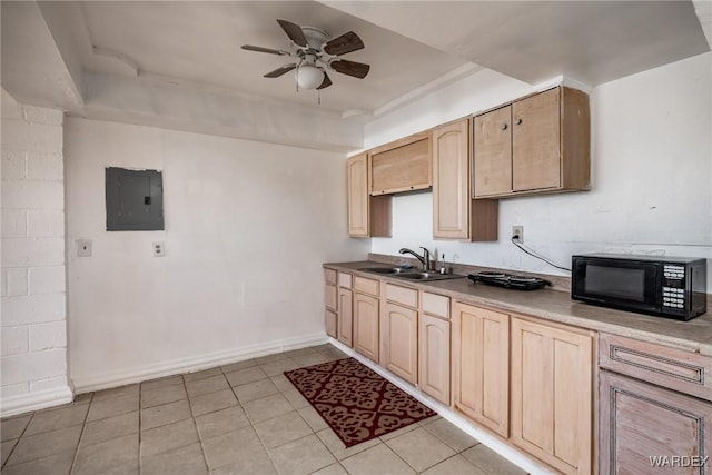 kitchen with electric panel, black microwave, a sink, and light brown cabinetry