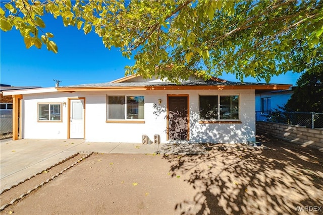 ranch-style house featuring a patio and fence