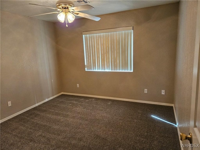 carpeted empty room with ceiling fan and baseboards