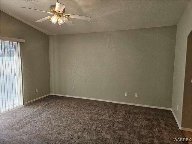 unfurnished room featuring vaulted ceiling, ceiling fan, dark carpet, and baseboards