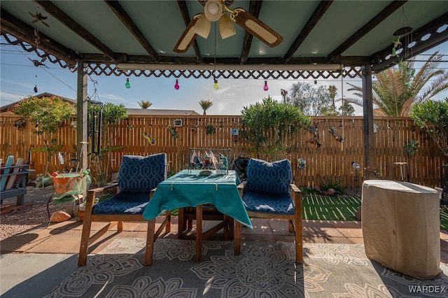 view of patio / terrace with a fenced backyard, outdoor dining area, a ceiling fan, and a gazebo