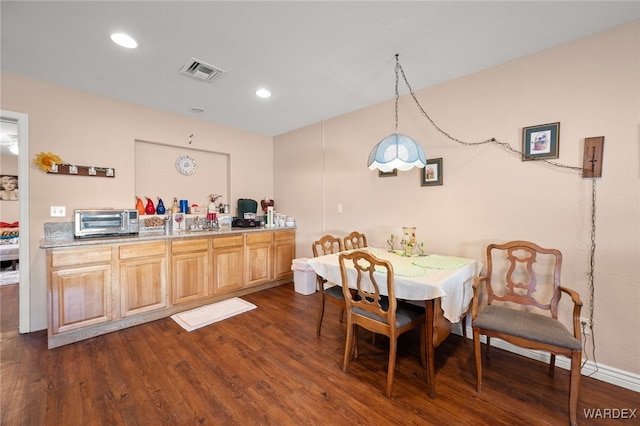 dining area featuring recessed lighting, dark wood finished floors, visible vents, and a toaster