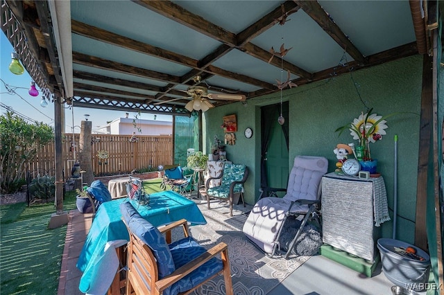 view of patio / terrace with ceiling fan, outdoor dining area, and fence