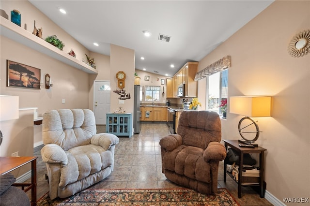 living room featuring light tile patterned floors, recessed lighting, visible vents, vaulted ceiling, and baseboards