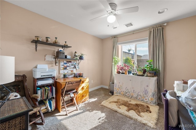 office featuring carpet, visible vents, ceiling fan, and baseboards