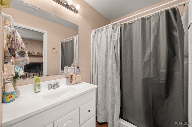 bathroom featuring shower / bath combo, vanity, and visible vents