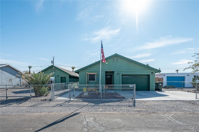 view of front facade with concrete driveway, a fenced front yard, an attached garage, and stucco siding