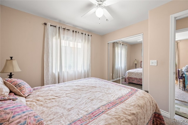 bedroom featuring carpet floors, a closet, baseboards, and a ceiling fan