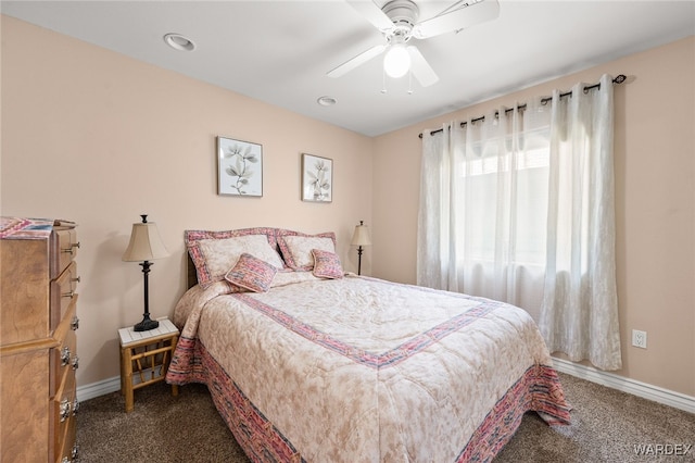 carpeted bedroom with a ceiling fan and baseboards