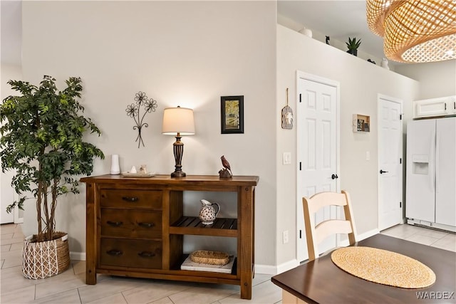 interior space featuring light tile patterned floors and baseboards