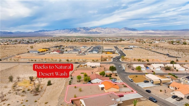 drone / aerial view with view of desert, a mountain view, and a residential view