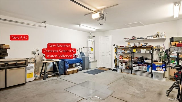 garage featuring secured water heater and a garage door opener