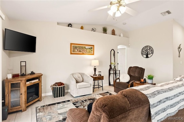 living area featuring light tile patterned floors, visible vents, lofted ceiling, arched walkways, and ceiling fan