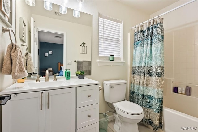 bathroom with vanity, shower / bath combination with curtain, toilet, and visible vents