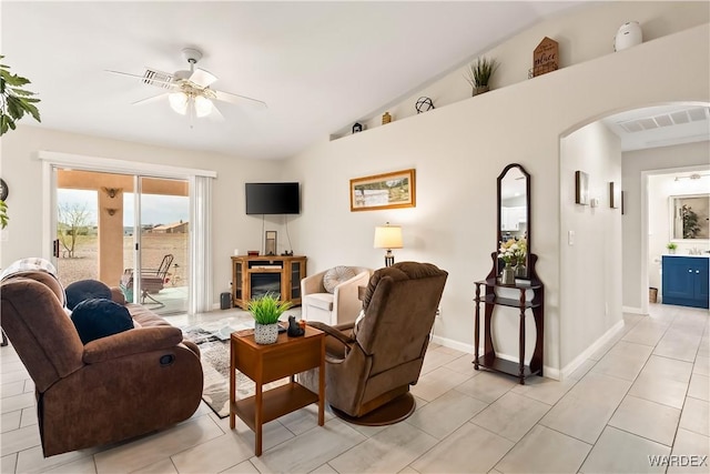 living area featuring visible vents, ceiling fan, lofted ceiling, light tile patterned floors, and arched walkways