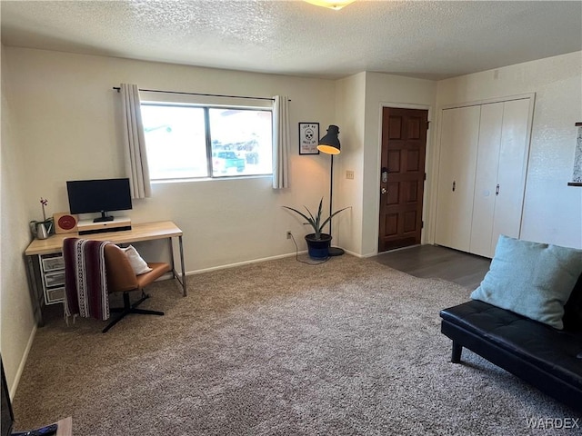 office area featuring carpet, baseboards, and a textured ceiling