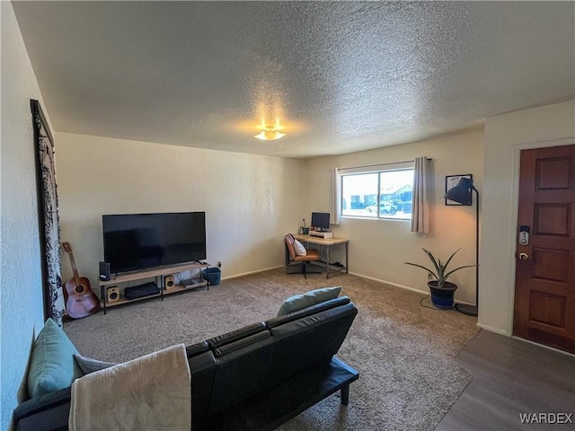 living room with a textured ceiling and baseboards