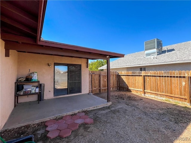 view of yard featuring a patio area, fence, and cooling unit