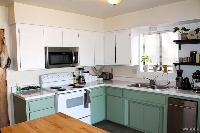 kitchen featuring open shelves, stainless steel appliances, a sink, and light countertops