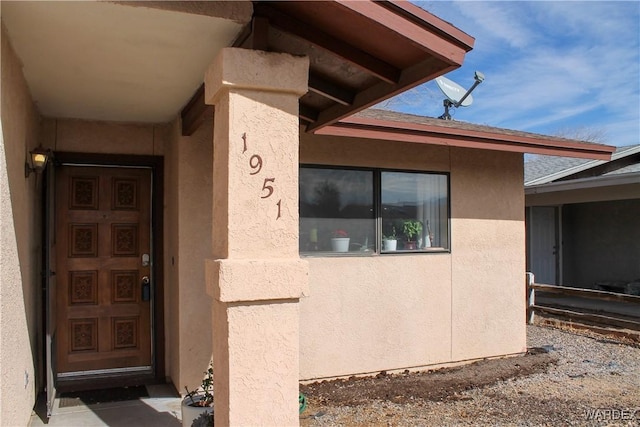 doorway to property with stucco siding