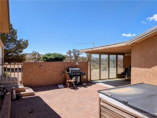 view of patio / terrace with grilling area and fence