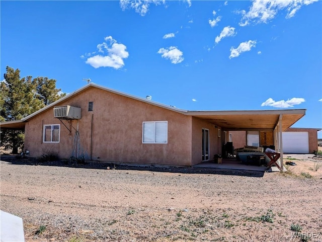 exterior space featuring stucco siding and an attached carport