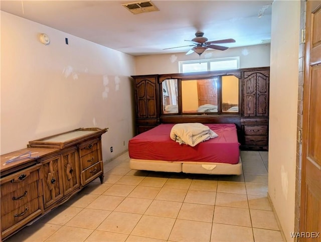 bedroom with visible vents, a ceiling fan, and light tile patterned flooring