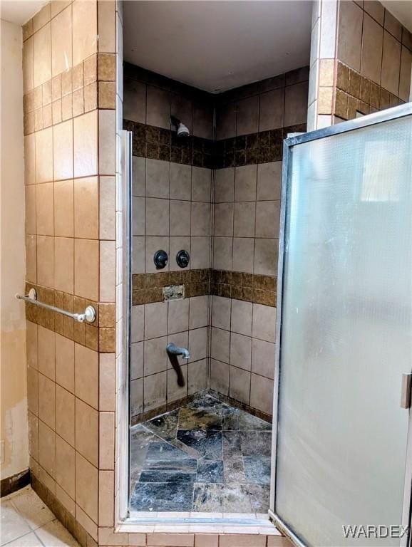 full bath featuring tile patterned floors and a stall shower