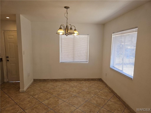 unfurnished dining area featuring baseboards, light tile patterned flooring, and a notable chandelier