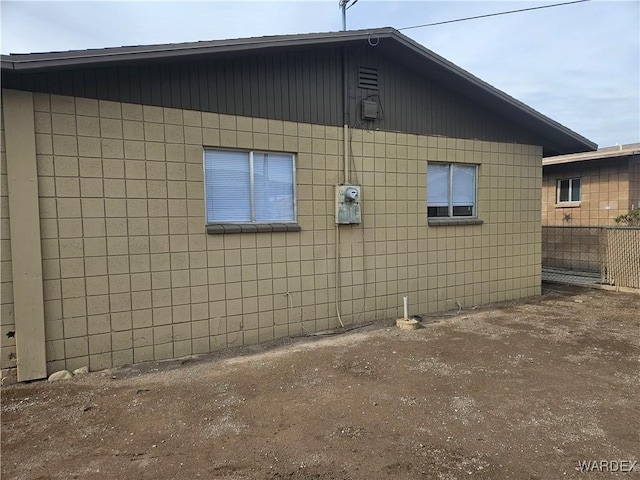 view of side of property featuring fence