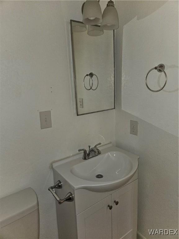 half bath with vanity and toilet