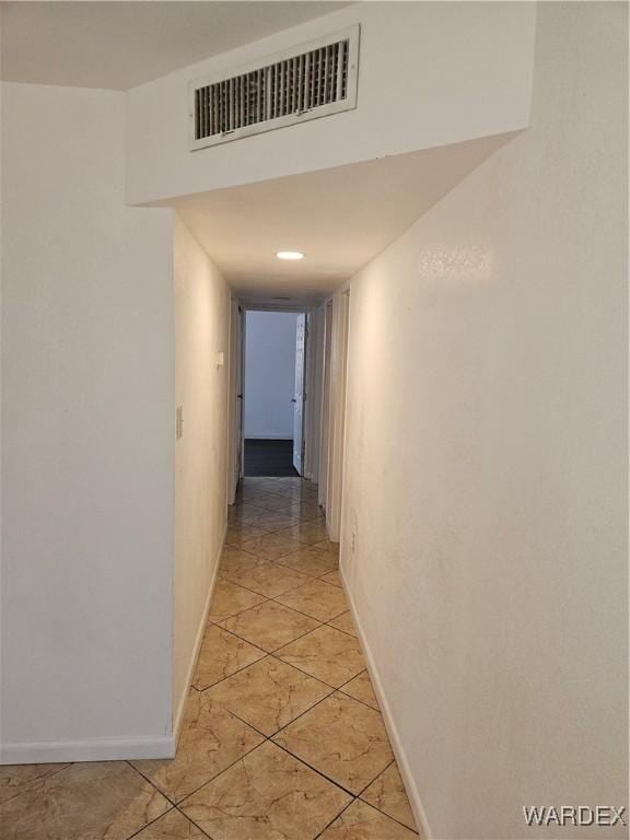 hallway featuring visible vents and baseboards