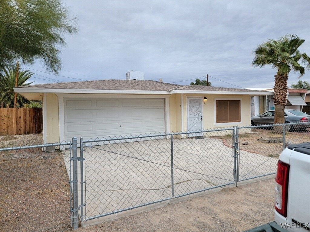 single story home featuring fence, stucco siding, and a gate