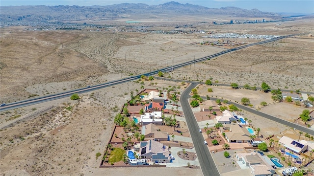 aerial view featuring a rural view, view of desert, and a mountain view