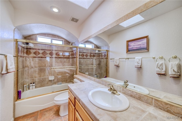 full bath with tile patterned flooring, visible vents, toilet, vanity, and shower / bathing tub combination