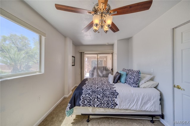 carpeted bedroom featuring a ceiling fan and baseboards