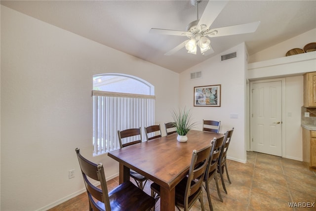 dining room featuring lofted ceiling, baseboards, a ceiling fan, and visible vents