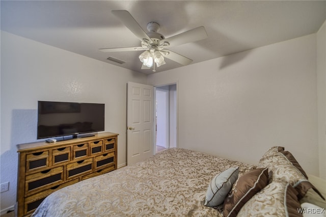 bedroom with carpet, visible vents, and ceiling fan