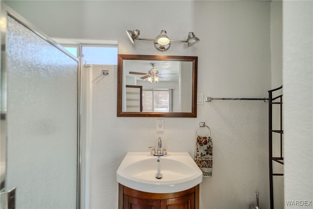 bathroom featuring plenty of natural light, a ceiling fan, and vanity