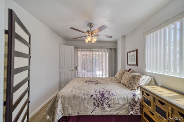 bedroom featuring ceiling fan, baseboards, multiple windows, and carpet