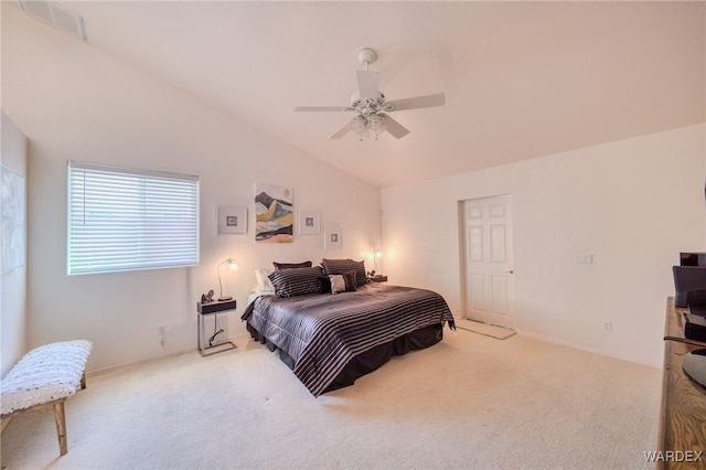 bedroom featuring carpet floors, a ceiling fan, vaulted ceiling, and visible vents