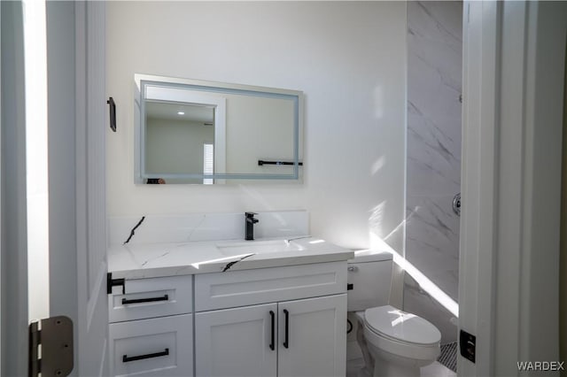 bathroom with toilet and vanity