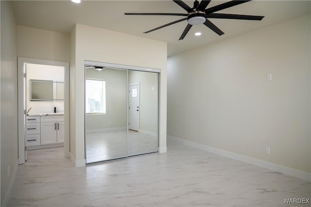 unfurnished bedroom featuring baseboards, ceiling fan, marble finish floor, a closet, and recessed lighting