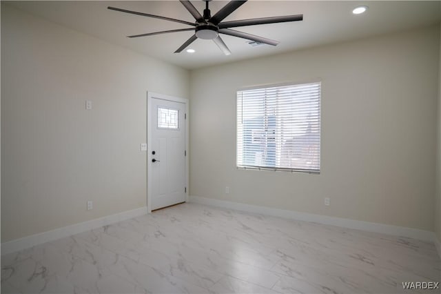 spare room featuring baseboards, marble finish floor, ceiling fan, and recessed lighting